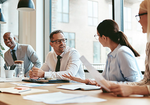 Business meeting with four colleagues in a bright office - www.mysoutherninsurance.com