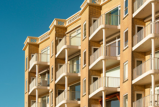 A row of modern, multi-story apartment buildings with balconies - www.mysoutherninsurance.com